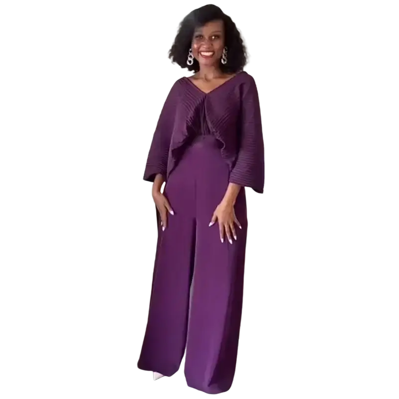 A woman wearing a vibrant purple satin two piece set with ruffled top and wide leg pants