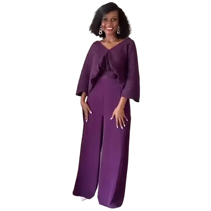 A woman wears a deep purple satin two piece set with ruffled sleeves and wide leg pants