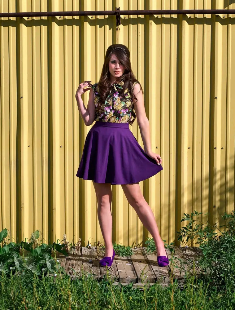 Purple pleated high waisted skater skirt with pockets made of soft fabric shown from the front side