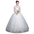 White Qidi lace off the shoulder wedding gown with lace detailing and flowing tulle ball gown skirt