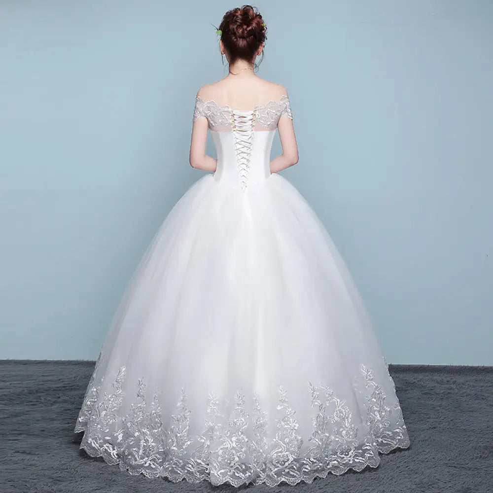 White off the shoulder ball gown wedding dress with lace detailing and corset back shown from the back side