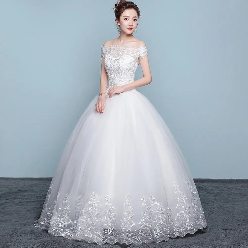 White off-the-shoulder ball gown wedding dress with silver lace detailing and voluminous tulle skirt by Qidi Lace