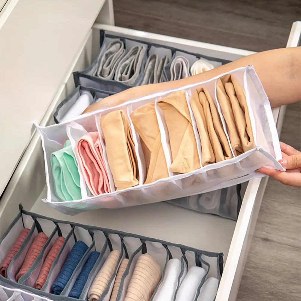 transparent plastic underwear organizer with grid 7grid 11grid compartments neatly holding multicolored folded underwear for efficient drawer storage.