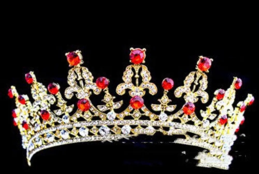 Ornate crystal queen bridal tiara in gold with red and clear crystals in a symmetrical design