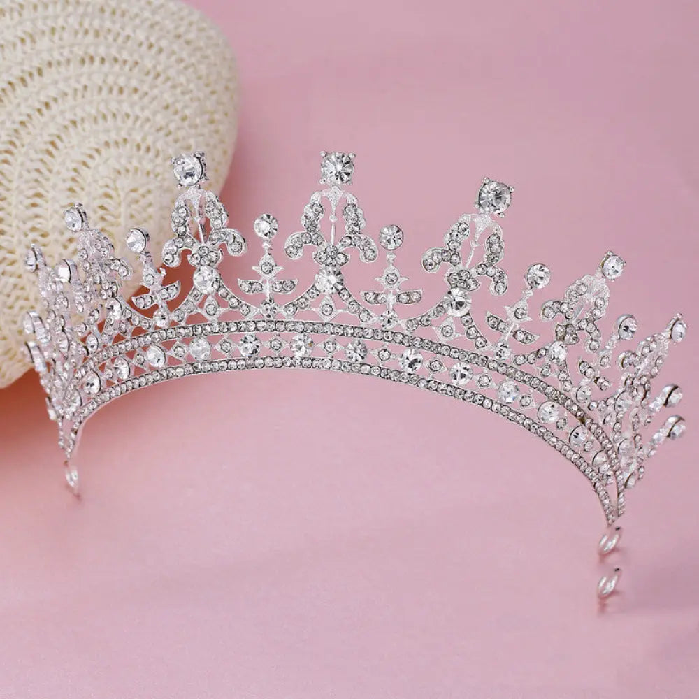 Ornate crystal queen bridal tiara in silver with intricate crystal embellishments and a delicate ornate design
