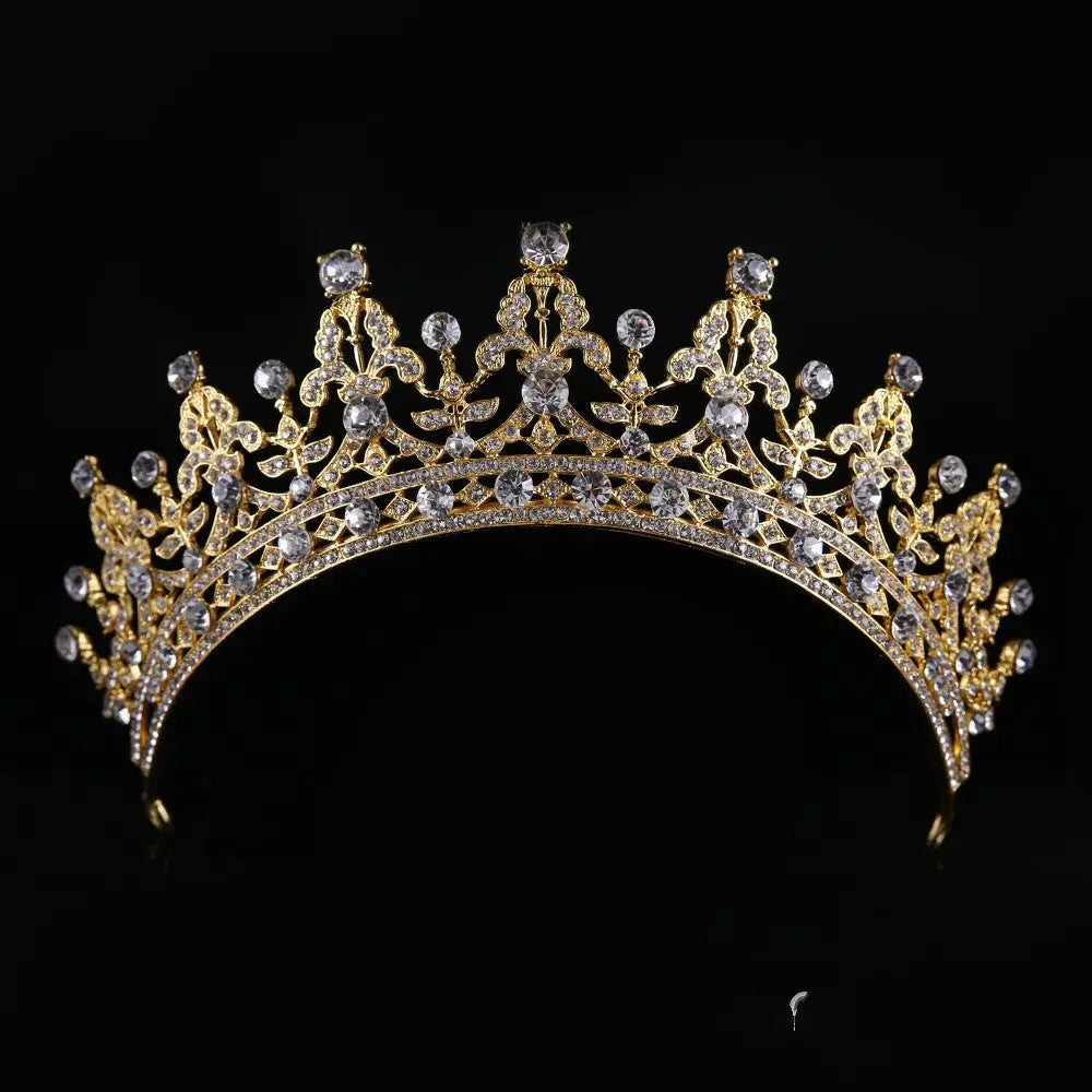Ornate crystal queen bridal tiara in gold and silver with sparkling clear crystals and intricate floral patterns
