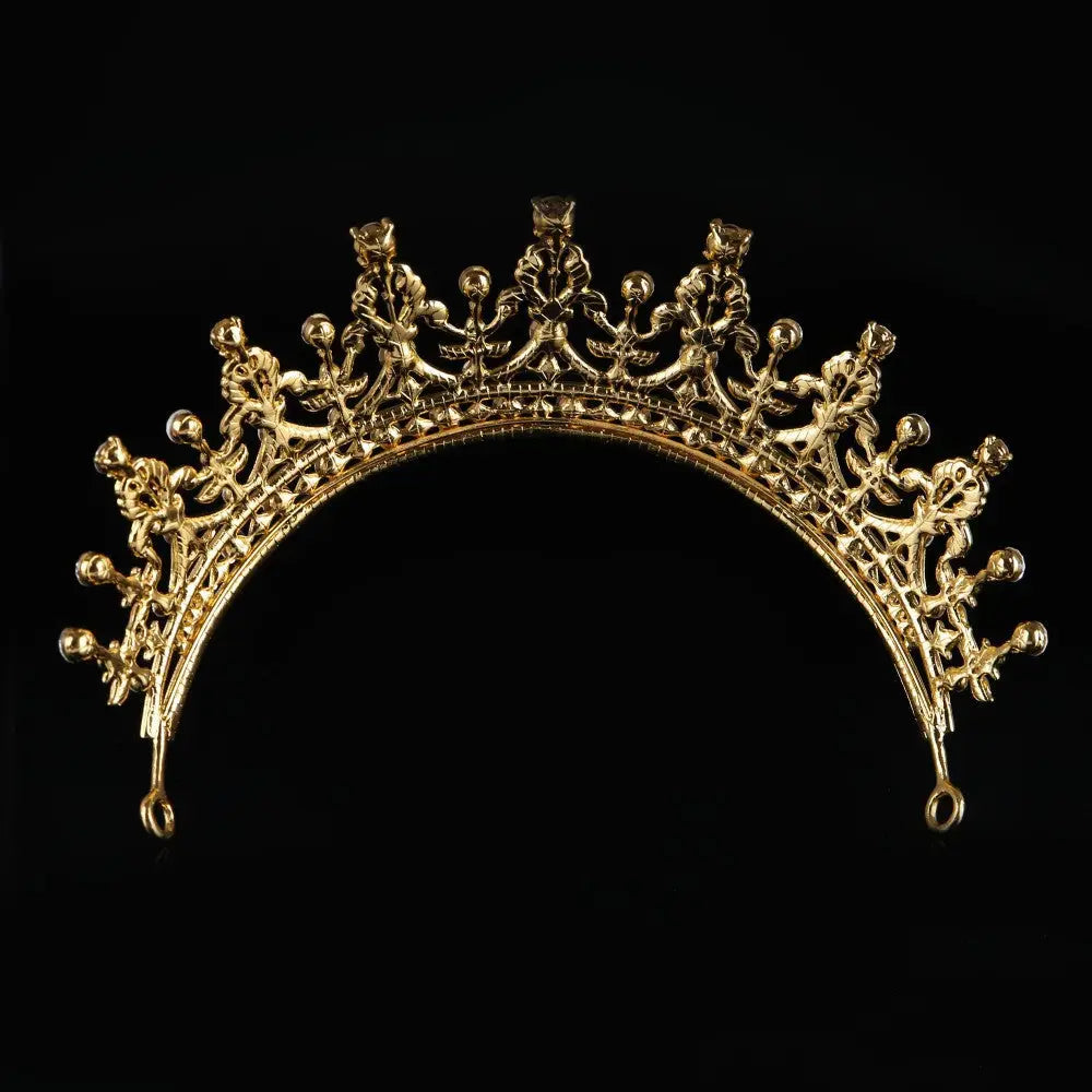Elegant gold-colored ornate crystal queen bridal tiara with intricate floral and scrollwork detailing