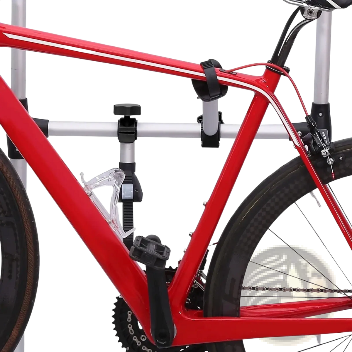 Red bicycle with silver frame and black components featuring a clear water bottle holder on a quick release rv bike rack strap frame holder