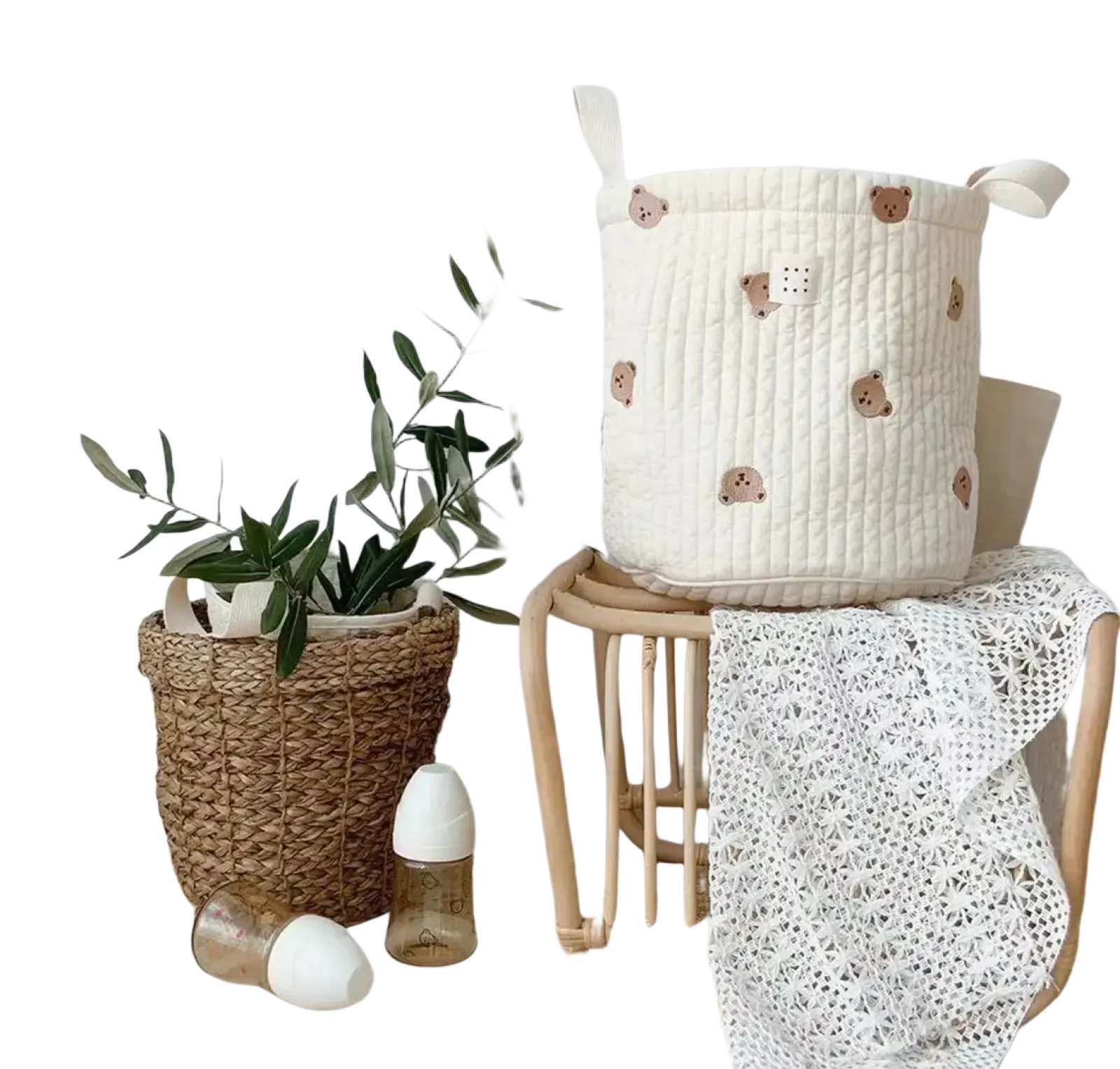 Cream-colored quilted baby diaper storage basket with embroidered brown bear faces and fabric handles for organization