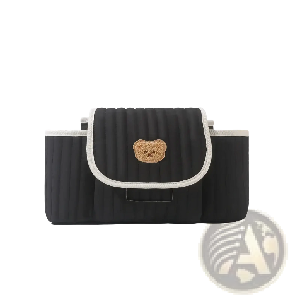 Black quilted car seat organizer with beige embroidered bear face and white trim for stroller use