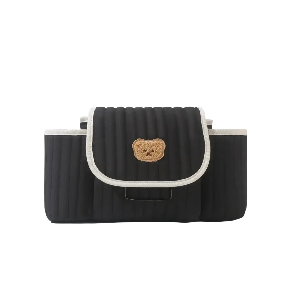 Black quilted car seat organizer with beige embroidered bear face and white trim for stroller use