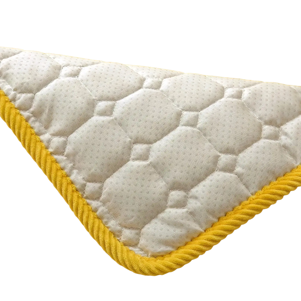 Bright yellow corduroy quilted non slip sofa cover protector with white hexagon patterned quilted backing and braided edge