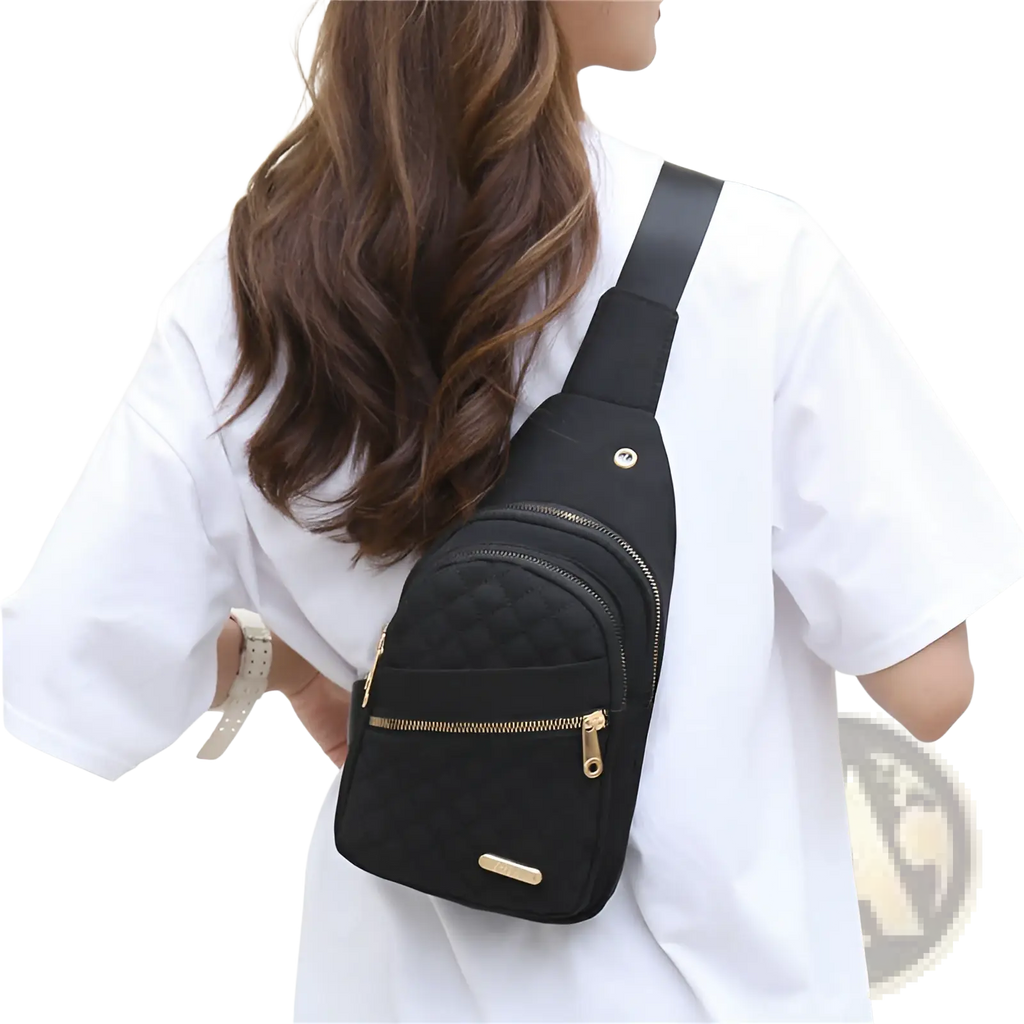 Black quilted crossbody slanted chest bag for women with gold-tone zippers and minimalist design