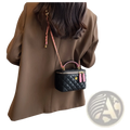 Black quilted diamond crossbody bag made of pu leather with pink braided strap and matching tassels