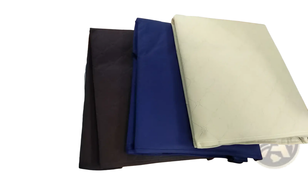 Stacked dark gray black navy blue and cream quilted fabric clothes storage bags with subtle textured patterns 3 pack set