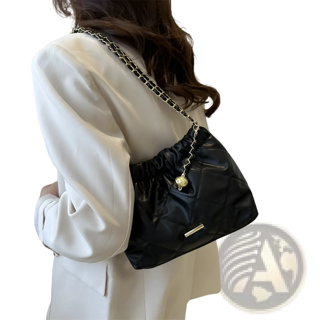 Black quilted faux leather crossbody shoulder bag with silver chain strap and gold-tone circular charm