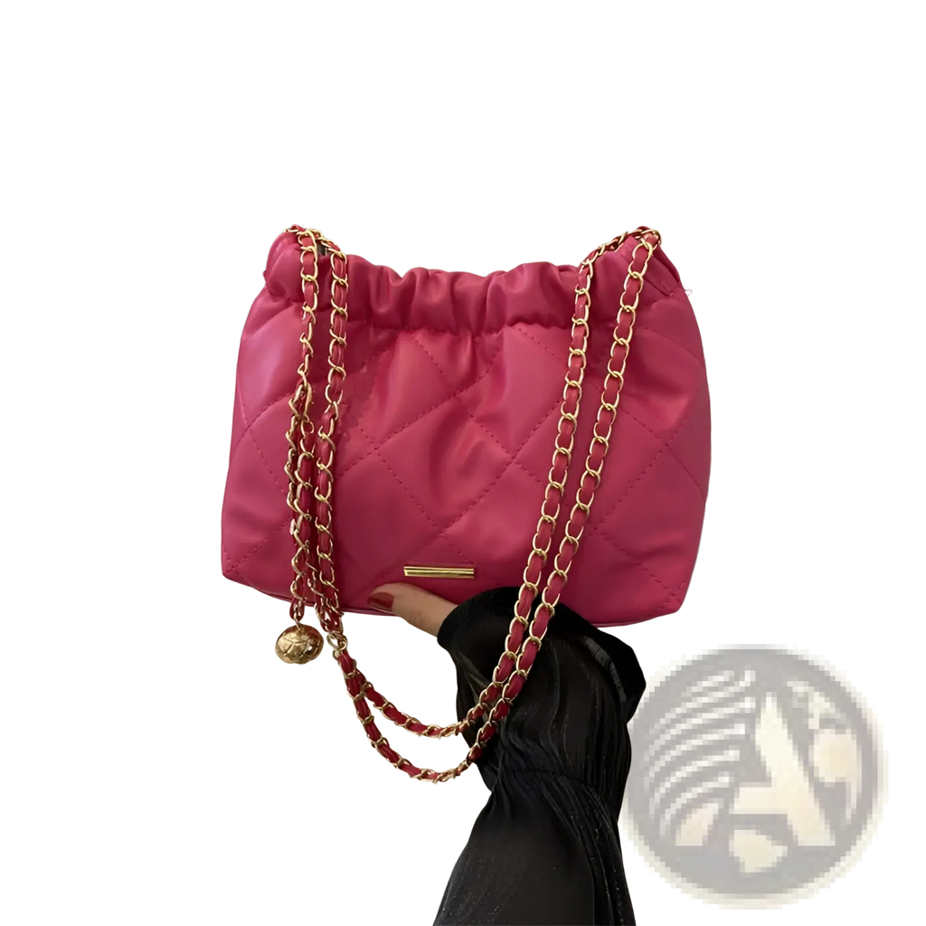 Vibrant pink quilted faux leather crossbody bag with gold-tone chain straps and decorative golden ball charm