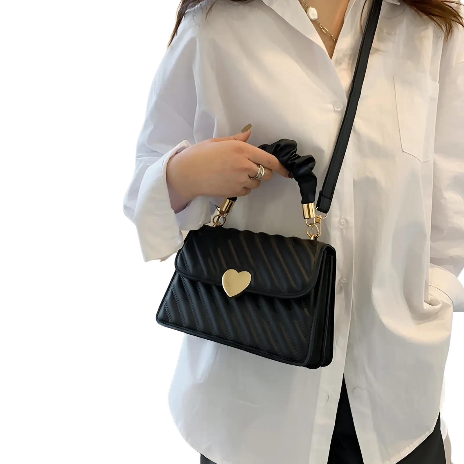 Black quilted leather crossbody bag with gold heart clasp and ruched handle for stylish everyday use
