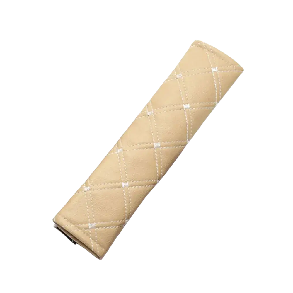 Beige quilted leather car seat belt cover with white stitching for added comfort and style in vehicles