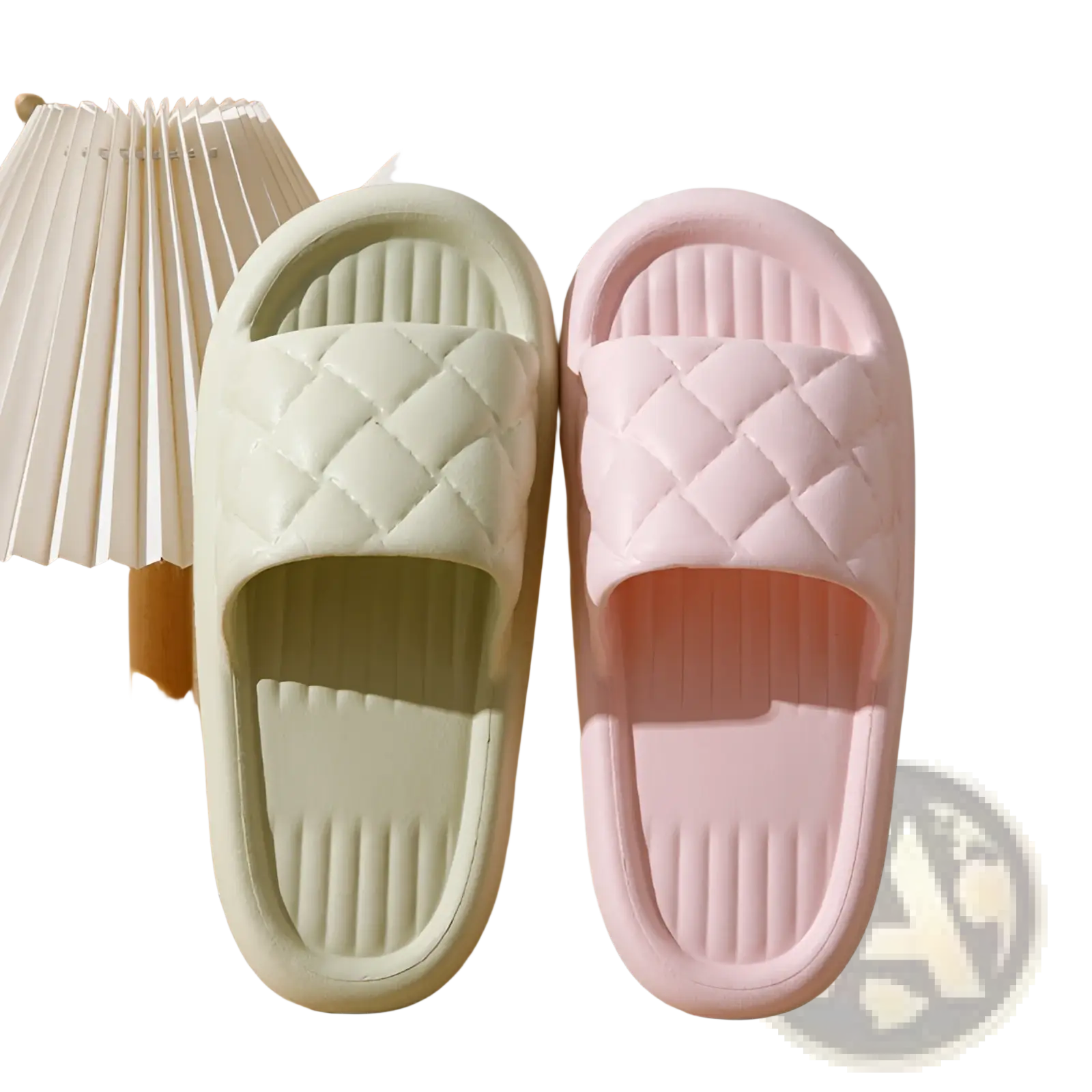 A pair of pastel-colored quilted non slip lightweight rubber slide sandals in soft mint and blush pink for home use