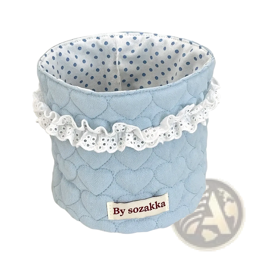 Light blue quilted fabric nursery storage basket with white lace trim and polka-dot interior by sozakka