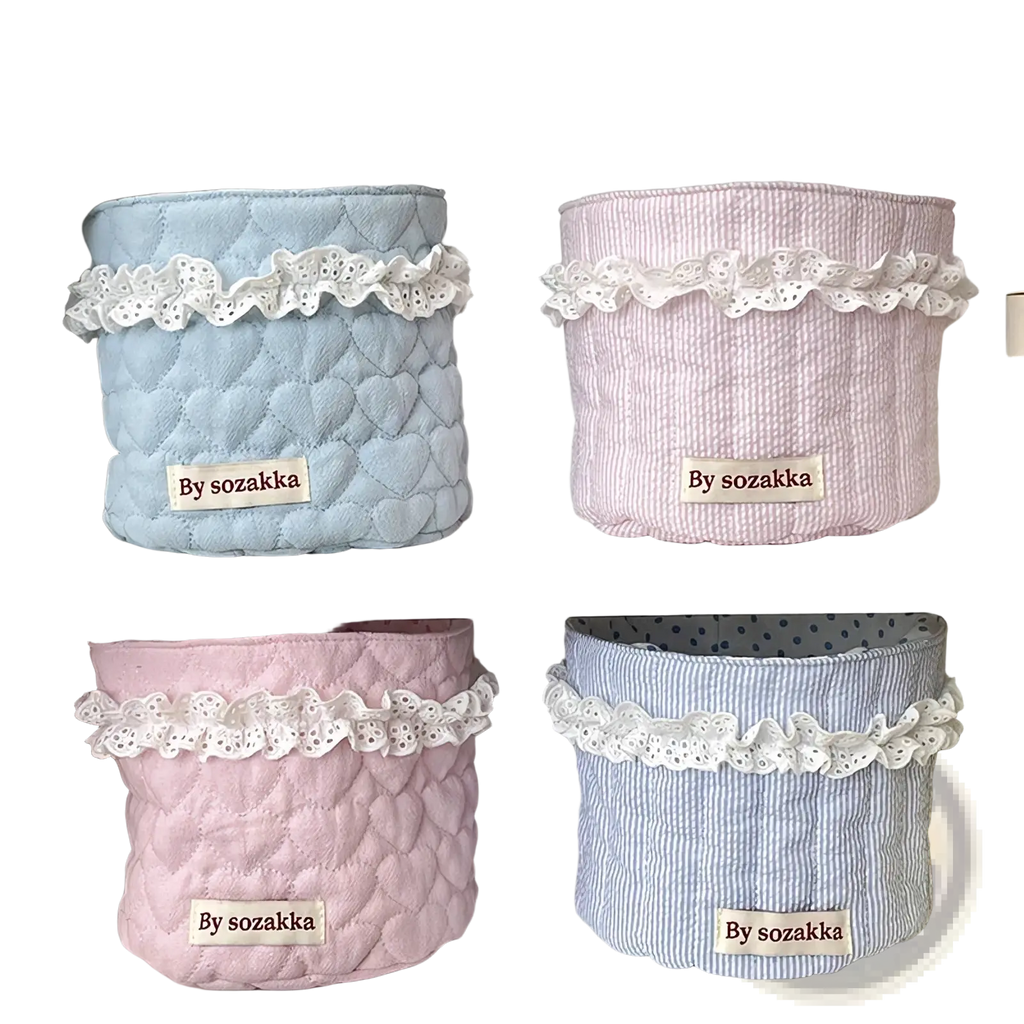 Pastel-colored quilted nursery storage baskets with delicate white lace trim and heart-patterned stitching