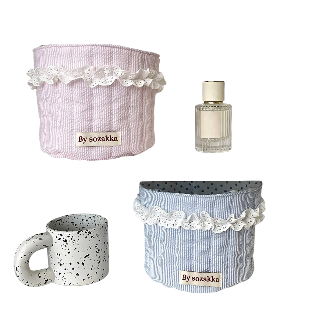 Quilted nursery storage baskets in pastel pink and blue stripes with white lace trim for organized storage