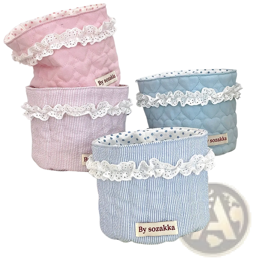 Quilted nursery storage baskets in pastel pink and blue fabric with white lace trim for organized storage