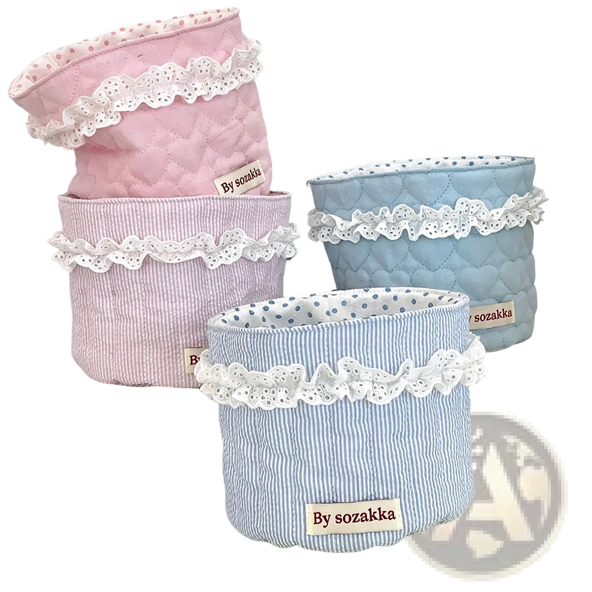 Quilted nursery storage baskets in pastel pink and blue fabric with white lace trim for organized storage
