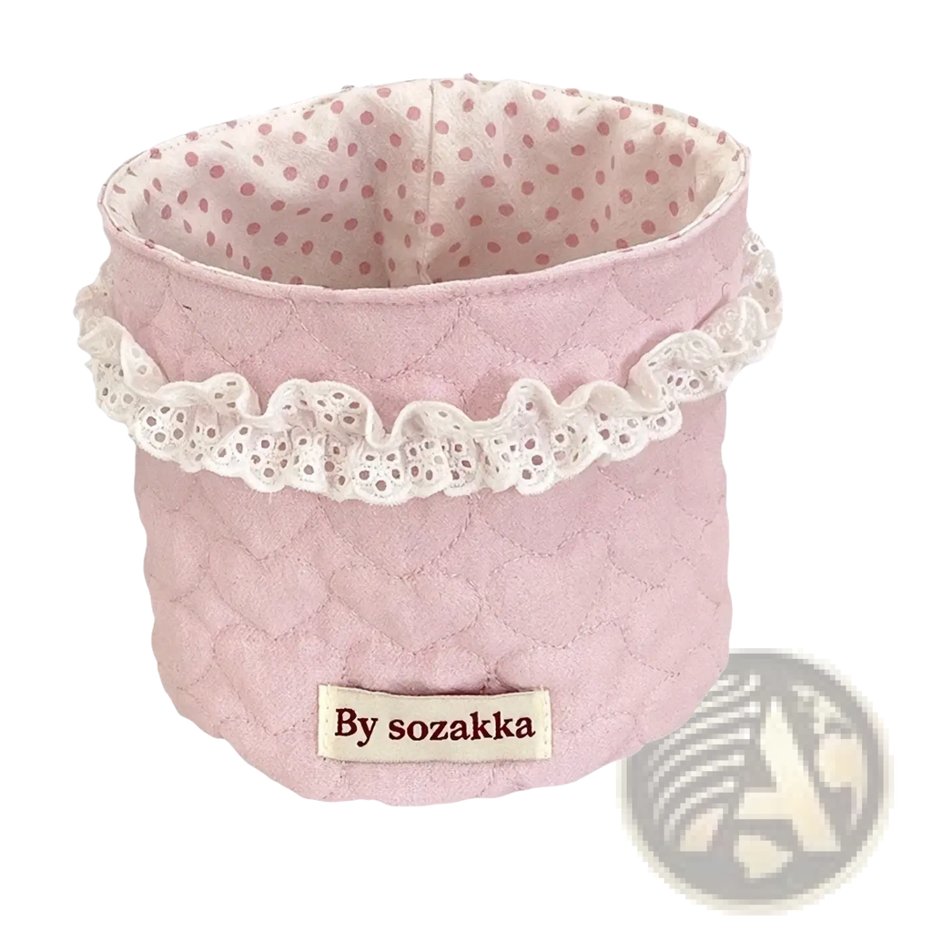 Pink quilted fabric nursery storage basket with white lace trim and polka-dotted interior by sozakka