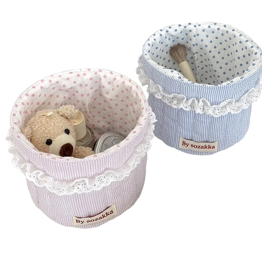 Quilted nursery storage basket in pink and white striped fabric with lace trim for organized baby rooms