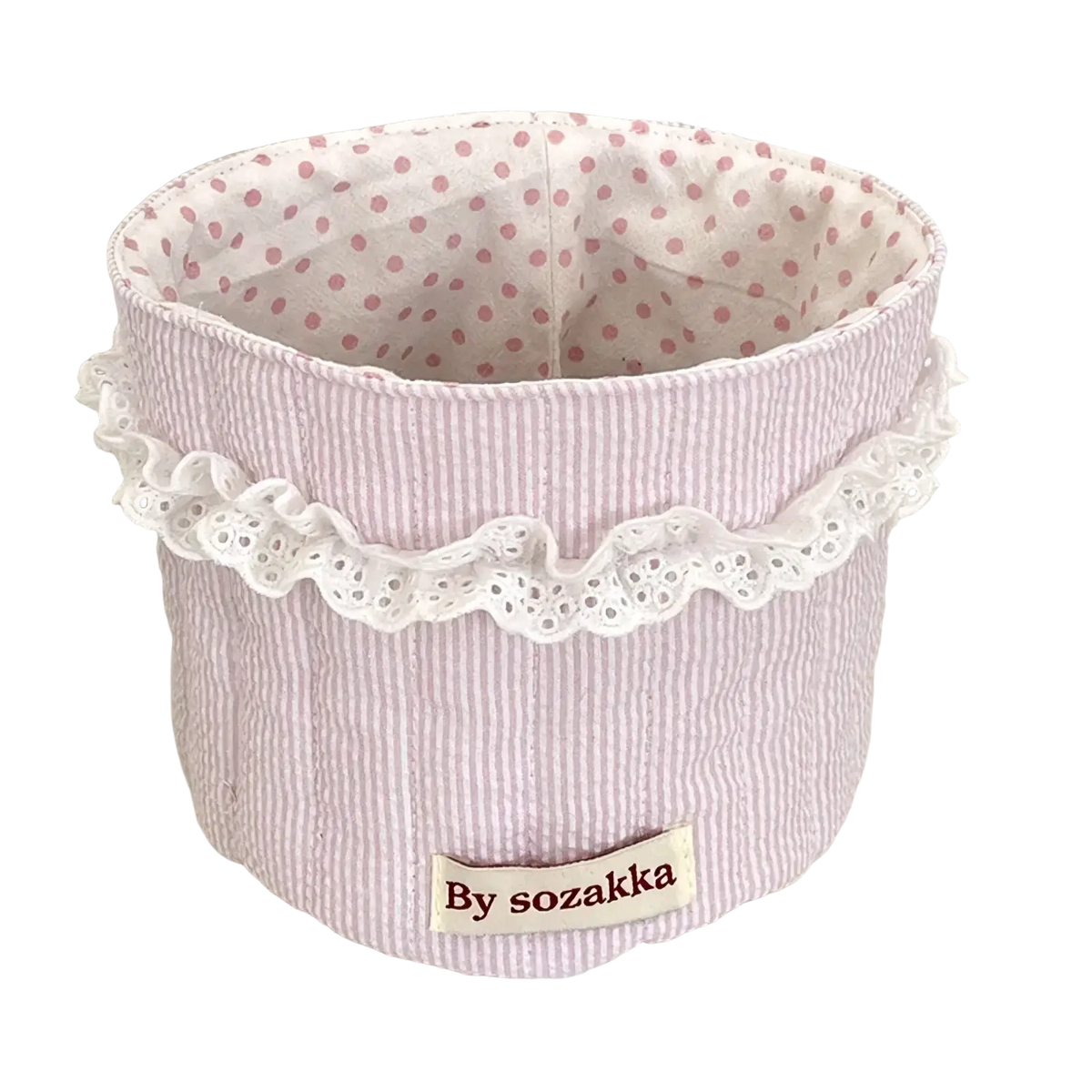 Quilted nursery storage basket in soft pink and white stripes with delicate lace trim around the top edge