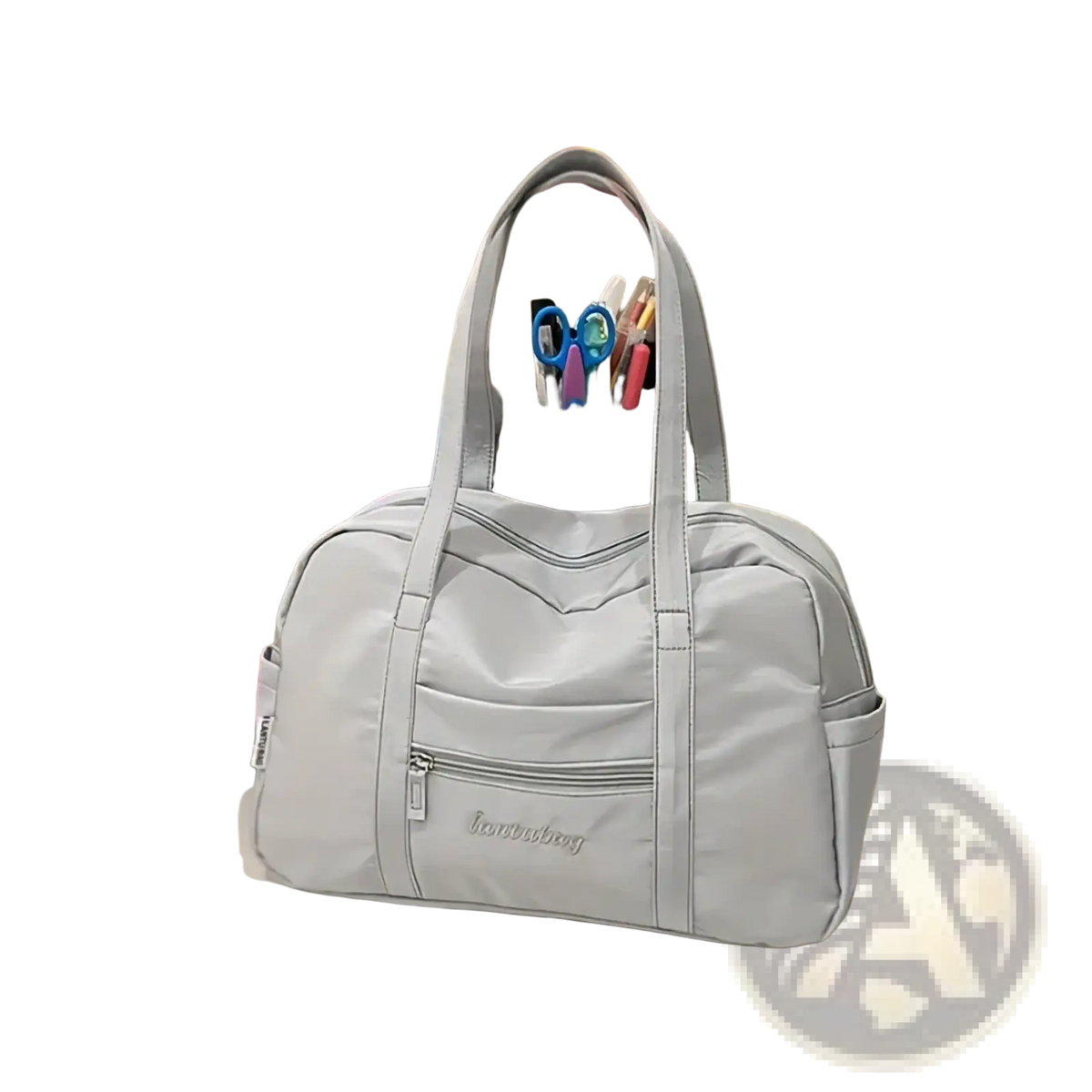 Light gray quilted nylon travel tote bag with structured dual handles and multiple zippered compartments with plush charm