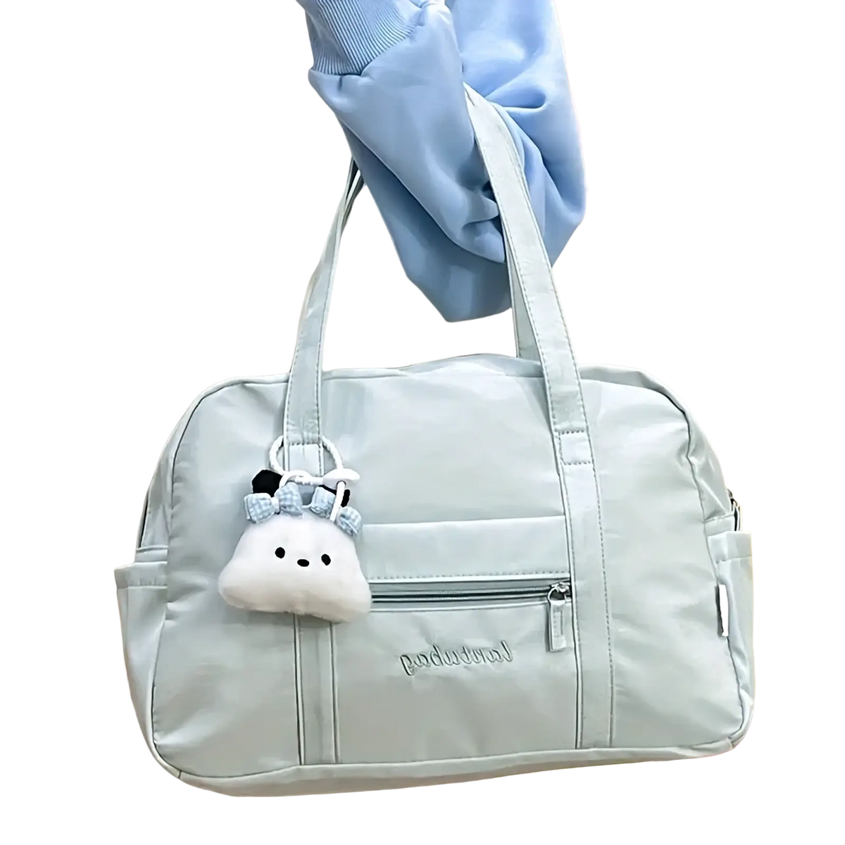 Light blue quilted nylon travel tote bag with plush cloud charm hanging from the handle
