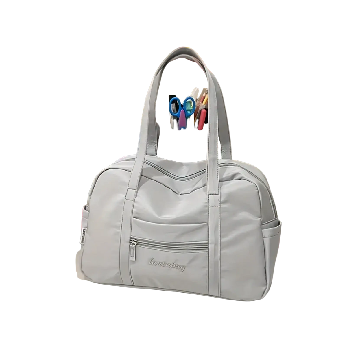 Light gray quilted nylon travel tote bag with structured dual handles and multiple zippered compartments with plush charm