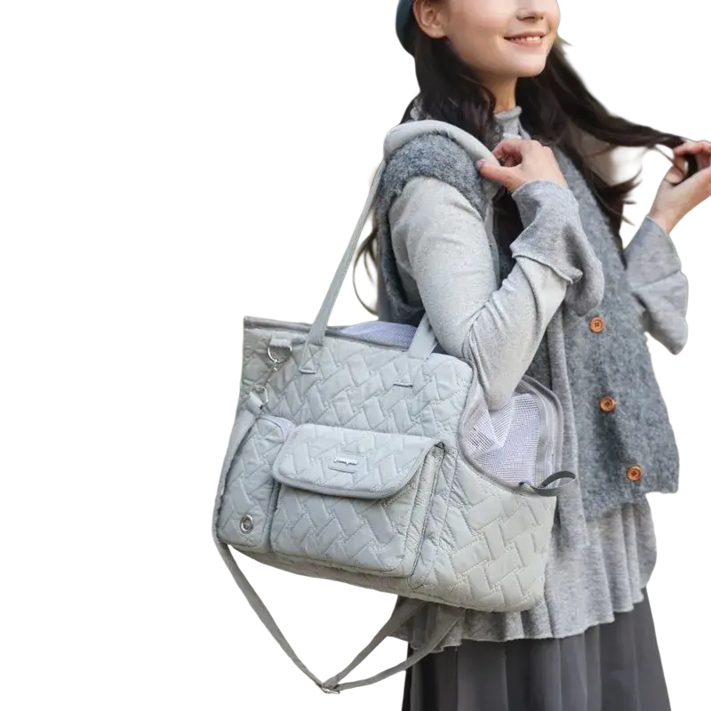 Light gray quilted pet carrier bag with mesh side pocket and adjustable shoulder strap for small cats and dogs