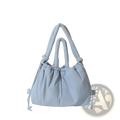 Light blue quilted puffer tote bag with padded handles and drawstring closure made of lightweight nylon