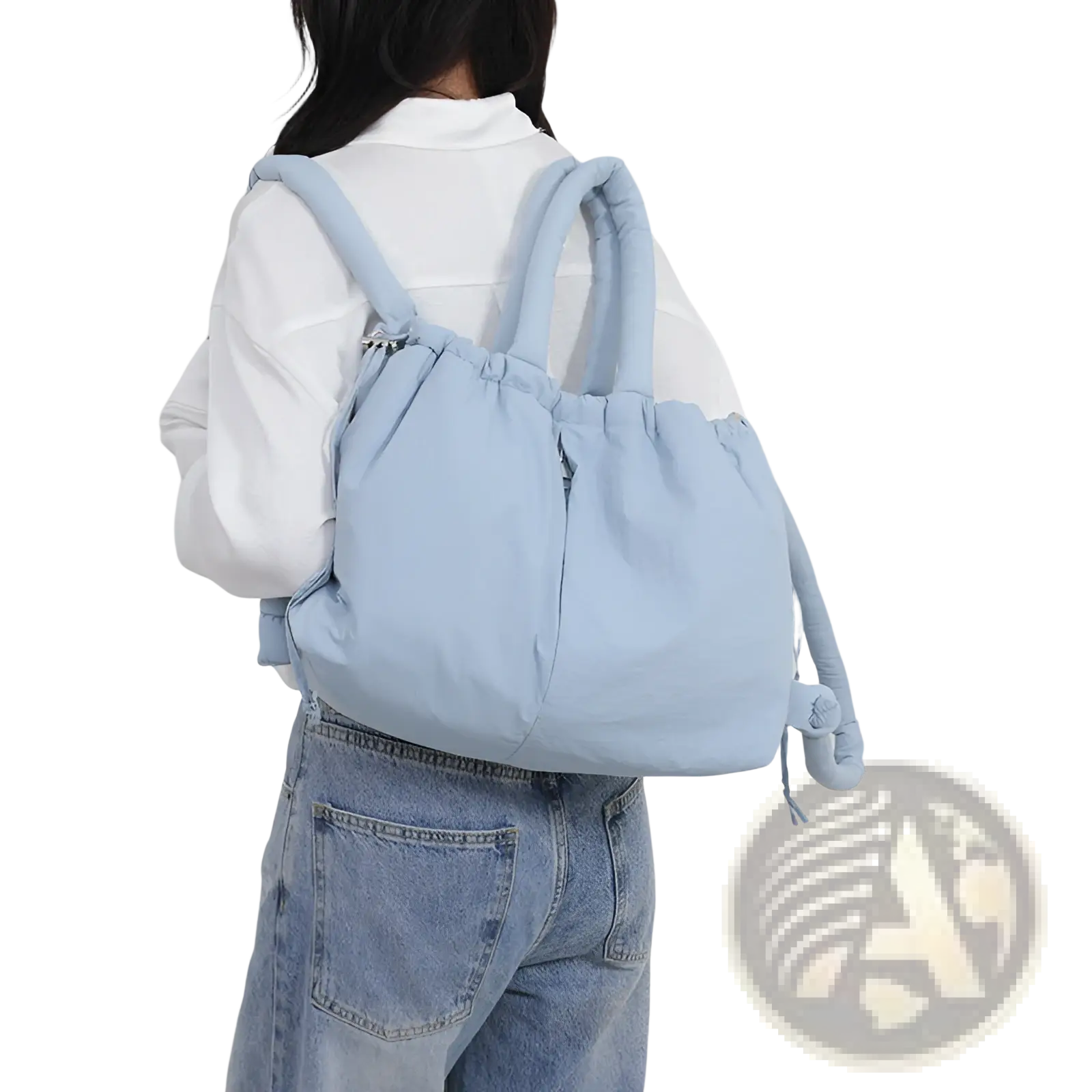 Light blue quilted puffer tote bag made of lightweight nylon with adjustable shoulder straps and drawstring closure