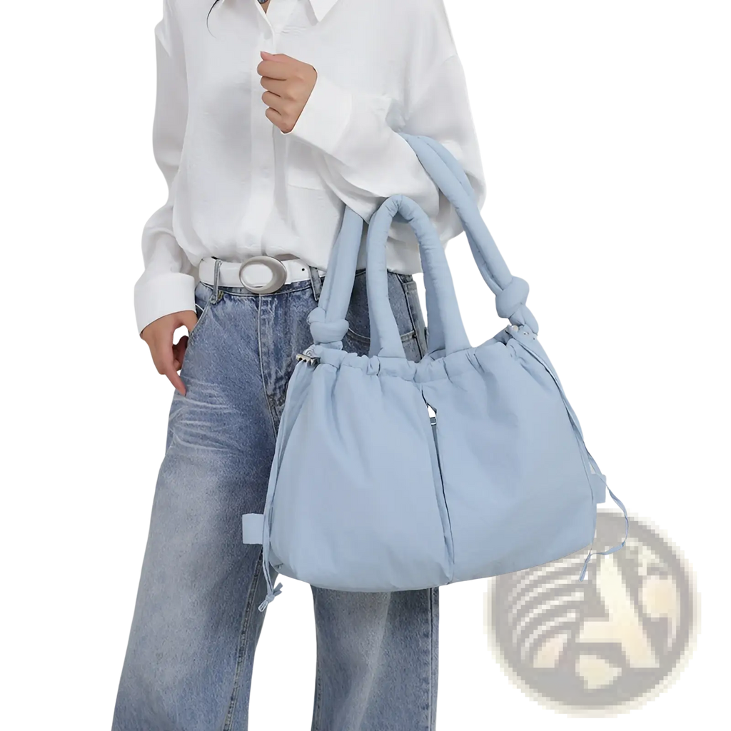 Light blue quilted puffer tote bag with knotted handles and drawstring closure made of lightweight nylon
