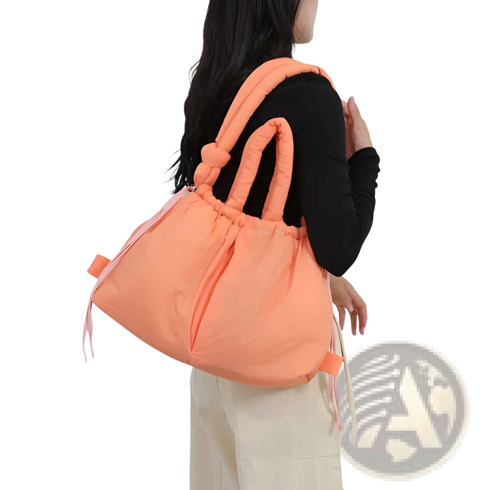 A soft peach-colored quilted puffer tote bag with thick handles and drawstring closure made of lightweight nylon