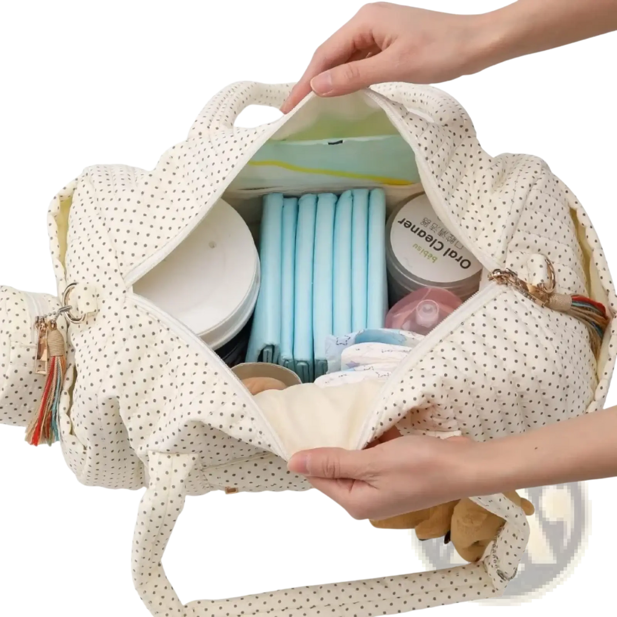 Quilted stroller organizer bag cream-colored polka-dot fabric with tassel accent featuring teddy bear design
