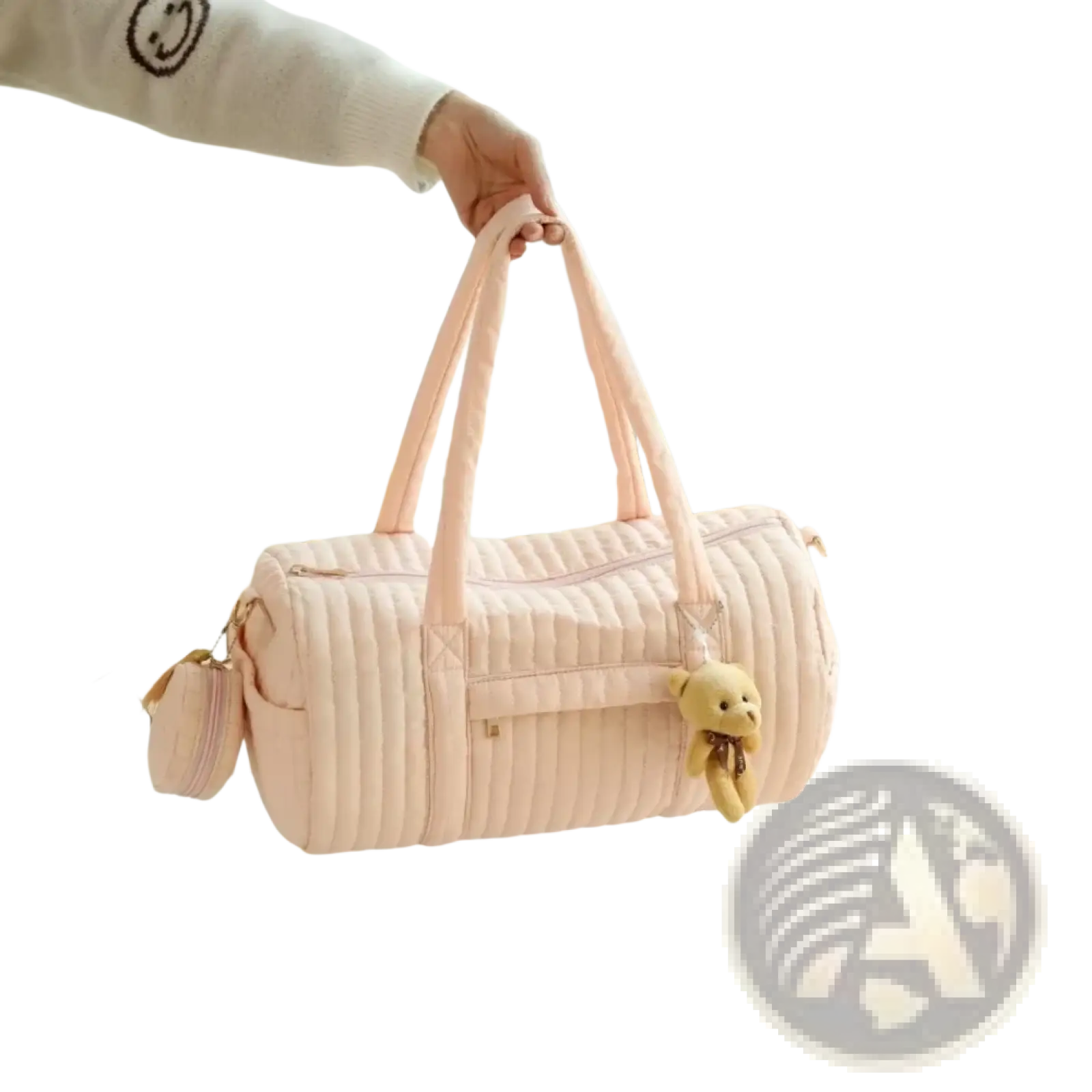 A soft pink quilted stroller organizer bag with long handles and a small teddy bear charm on the side