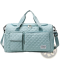 Light blue quilted large waterproof travel duffel bag with two front pockets and adjustable shoulder strap