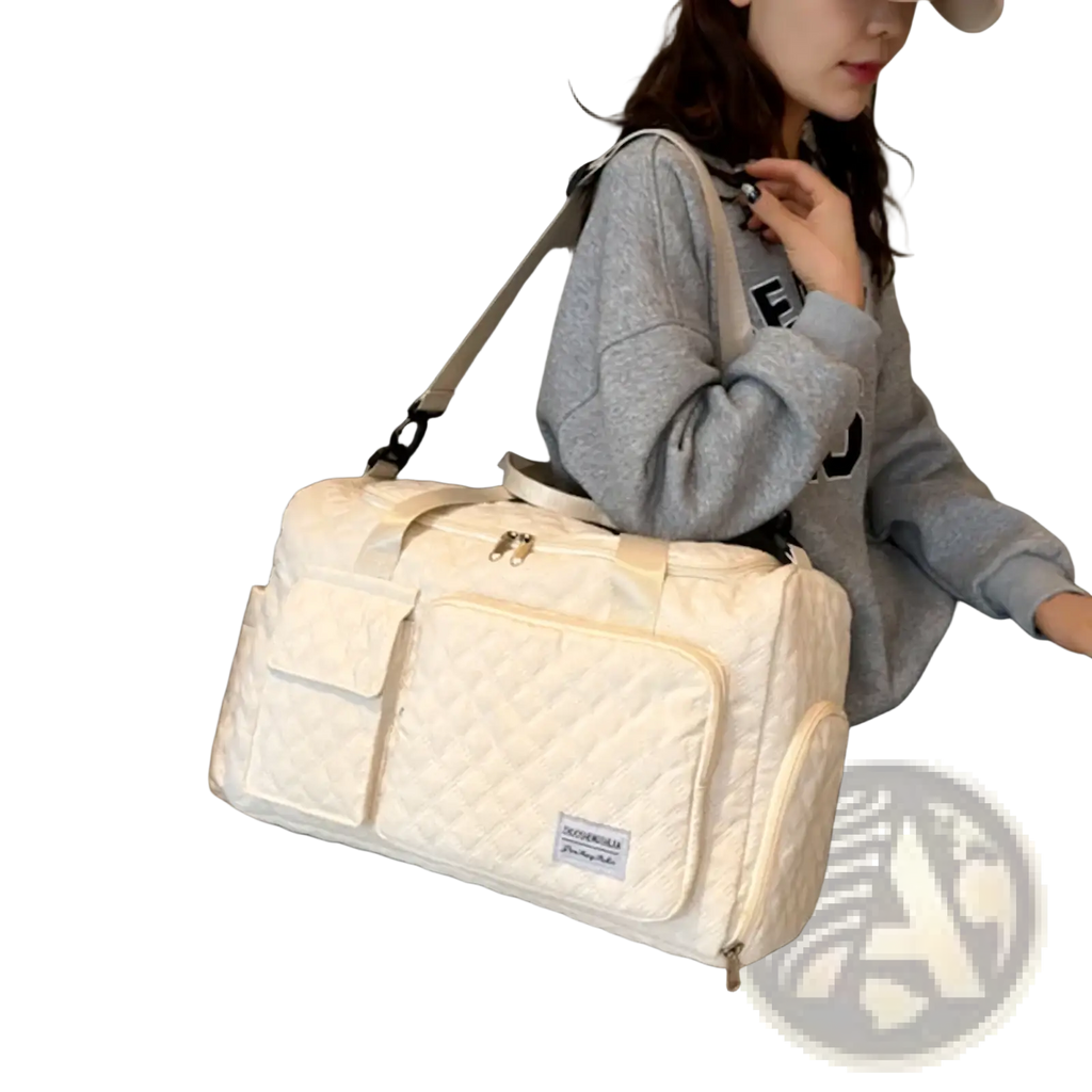 Cream-colored quilted large travel duffel bag with front pocket and adjustable shoulder strap waterproof tote
