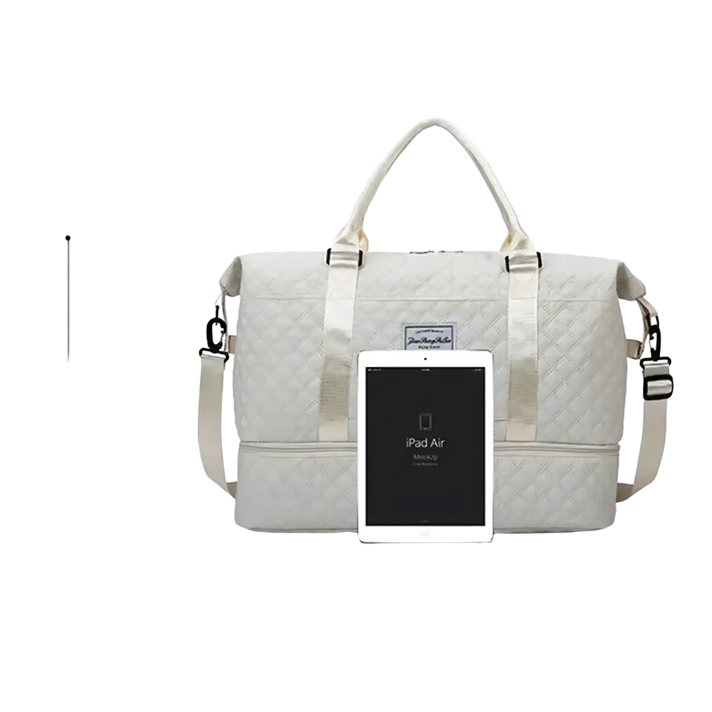 Cream-colored quilted large travel duffel bag with adjustable shoulder strap and top handles for weekender use