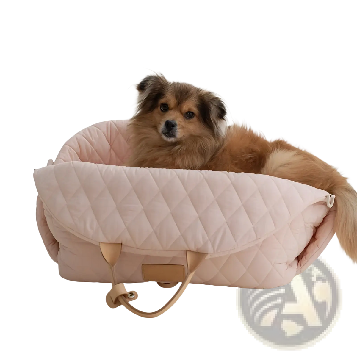Quilted travel pet carrier bag in soft blush pink with tan leather handles and a matching rectangular tag
