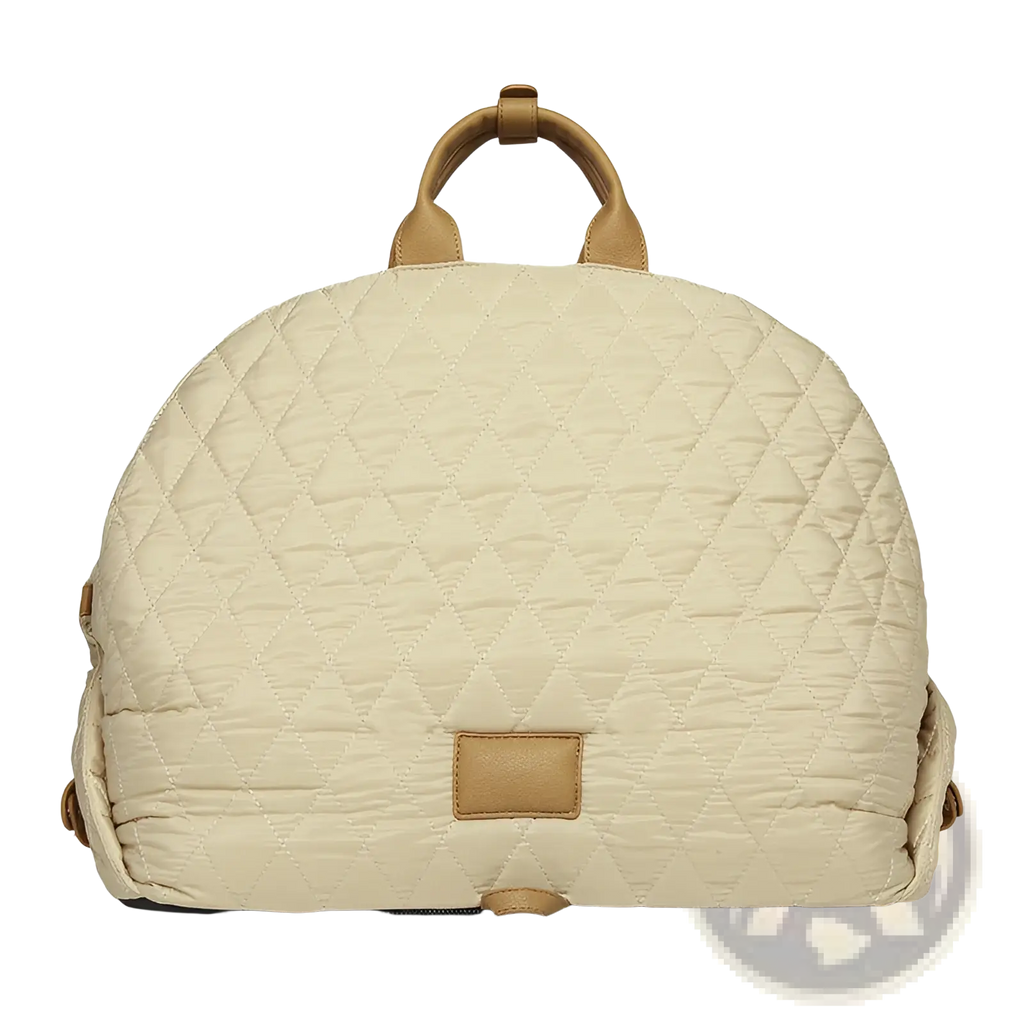 Beige quilted travel pet carrier bag with tan leather handles and matching rectangular patch for easy carrying