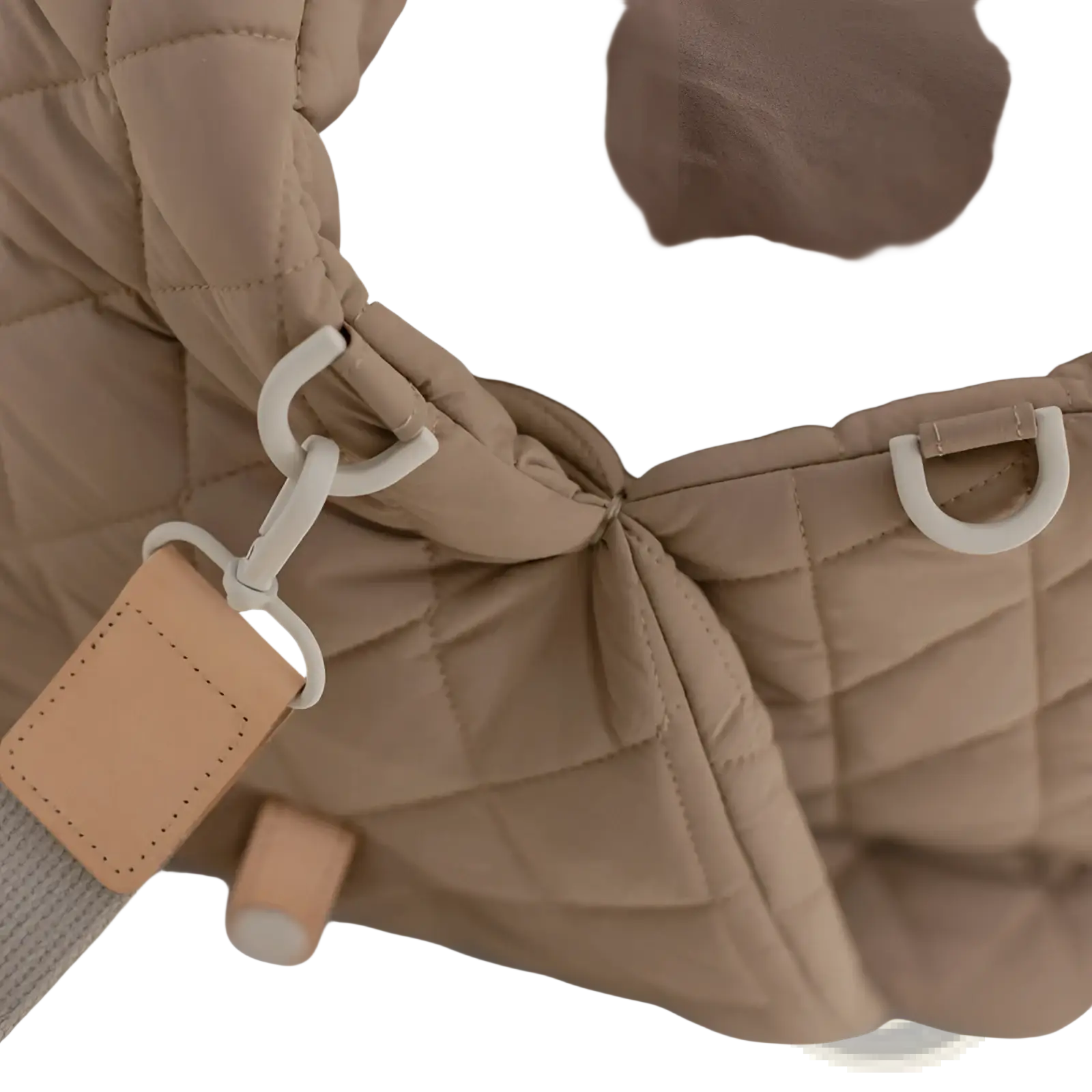 Beige quilted travel pet carrier bag featuring a puffer jacket style with white plastic hardware and tan leather tag