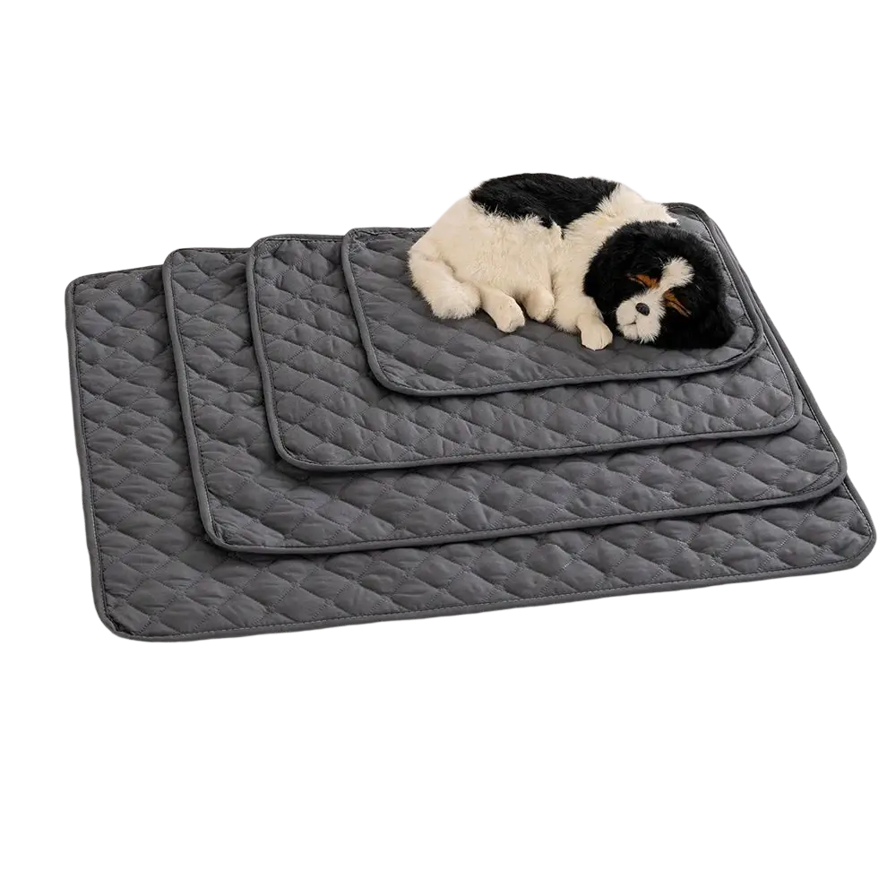 Set of three gray quilted waterproof pet mats with a black and white plush dog on top for furniture protection
