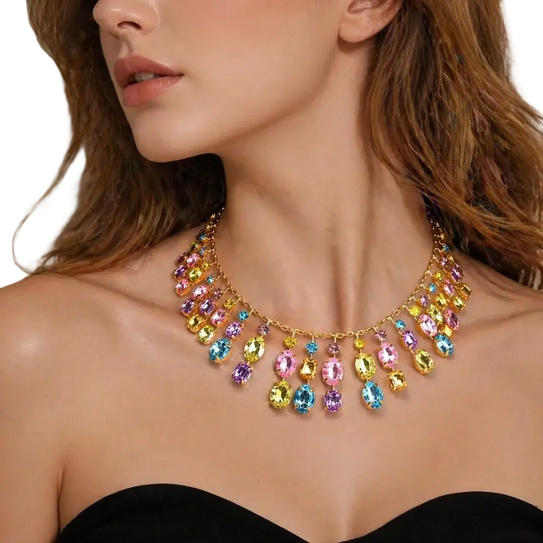 A vibrant rainbow crystal tassel choker necklace with cascading pink yellow blue and purple gemstones on gold chain